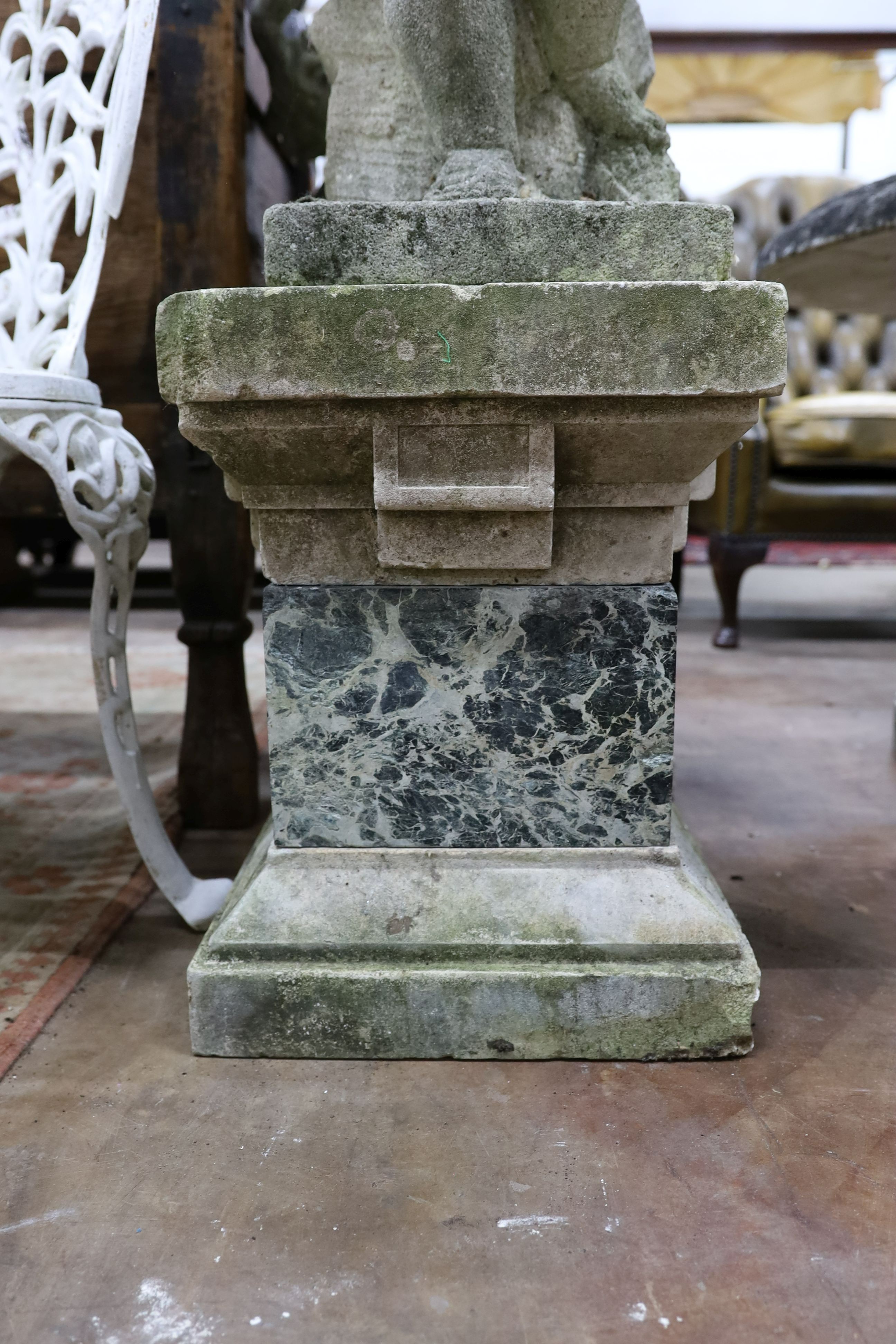 A pair of reconstituted stone cherub and dove garden ornaments on faux marble plinths, height 116cm